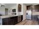 Kitchen featuring stainless steel appliances, granite countertops, and dark brown cabinets at 8861 Ventura St, Commerce City, CO 80022