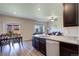 Open-concept kitchen featuring granite countertops and stainless-steel appliances, connected to living area at 8861 Ventura St, Commerce City, CO 80022