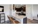 Kitchen with seating area featuring stainless steel appliances, granite countertops, and dark brown cabinets at 8861 Ventura St, Commerce City, CO 80022