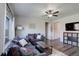 Cozy living room with stylish decor, ceiling fan, and a view into other parts of the home at 8861 Ventura St, Commerce City, CO 80022