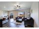 Bright living room with hardwood floors, neutral paint, ceiling fan, and access to the backyard at 8861 Ventura St, Commerce City, CO 80022