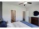 A main bedroom with two entrances visible, ceiling fan, and view of the closet and ensuite at 8861 Ventura St, Commerce City, CO 80022