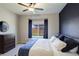 Comfortable main bedroom with a ceiling fan, views of the backyard, and a stylish dresser at 8861 Ventura St, Commerce City, CO 80022