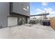 Spacious backyard with concrete patio, a modern gray house, and a covered parking area at 2922 W 26Th Ave # 1, Denver, CO 80211