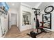 Basement gym featuring modern workout equipment, wood floors, recessed lighting, and large mirror at 2922 W 26Th Ave # 1, Denver, CO 80211