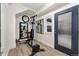 Basement gym with workout equipment, wood floors, a large wall mirror, and an egress door at 2922 W 26Th Ave # 1, Denver, CO 80211