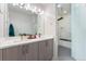 Bathroom featuring double sinks, modern vanity, and a sleek glass-enclosed shower with stylish tile work at 2922 W 26Th Ave # 1, Denver, CO 80211