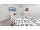 A bedroom with a mounted TV, a white dresser, and white doors, creating a clean and modern living space at 2922 W 26Th Ave # 1, Denver, CO 80211