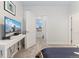 Modern bedroom with a mounted TV, desk, and view into the next room at 2922 W 26Th Ave # 1, Denver, CO 80211