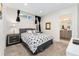 A modern bedroom with a gray bed frame, patterned bedding, and stylish black curtains near the attached bathroom at 2922 W 26Th Ave # 1, Denver, CO 80211