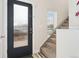 Welcoming entryway featuring a frosted glass door, staircase with carpet runner, and neutral paint at 2922 W 26Th Ave # 1, Denver, CO 80211