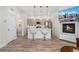 Open-concept kitchen featuring a large island with bar seating, fireplace, and seamless access to the living spaces at 2922 W 26Th Ave # 1, Denver, CO 80211