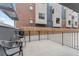 Private outdoor patio area with metal railing and chairs, perfect for relaxing near modern brick home at 2922 W 26Th Ave # 1, Denver, CO 80211