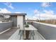 A rooftop deck featuring a glass table, seating, and string lights, ideal for outdoor gatherings at 2922 W 26Th Ave # 1, Denver, CO 80211