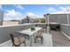A rooftop deck with a glass table, chairs, a grill, and string lights offering an inviting outdoor space at 2922 W 26Th Ave # 1, Denver, CO 80211