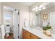 Well-lit bathroom with a vanity, toilet, and window for natural light at 9804 Martin Luther King Blvd, Denver, CO 80238