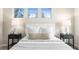 Bedroom featuring large windows, bedside lamps, and bedside tables at 9804 Martin Luther King Blvd, Denver, CO 80238