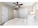 Bright bedroom featuring a ceiling fan, closet, and neutral walls at 9804 Martin Luther King Blvd, Denver, CO 80238