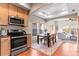 Bright kitchen and dining area open to living room with hardwood floors and natural light at 9804 Martin Luther King Blvd, Denver, CO 80238