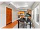 Dining area featuring an archway, a dark wood table, and a front door at 9804 Martin Luther King Blvd, Denver, CO 80238