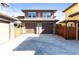 Front exterior of the two-story home featuring a two-car garage, brown trim, and a concrete driveway at 9804 Martin Luther King Blvd, Denver, CO 80238