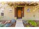 Charming home entrance with decorative columns and landscaped front yard at 9804 Martin Luther King Blvd, Denver, CO 80238