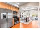 Modern kitchen featuring stainless steel appliances and hardwood floors, connecting to the dining area at 9804 Martin Luther King Blvd, Denver, CO 80238