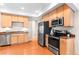Spacious kitchen showcasing stainless steel appliances, wood cabinets, and ample counter space at 9804 Martin Luther King Blvd, Denver, CO 80238