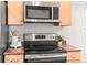 Close-up of kitchen appliances and cabinetry featuring stainless steel finishes and dark countertops at 9804 Martin Luther King Blvd, Denver, CO 80238