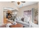 Open floor plan of living room adjacent to kitchen and dining area with vaulted ceiling and fan at 9804 Martin Luther King Blvd, Denver, CO 80238