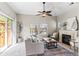 Comfortable living room with fireplace, ceiling fan, large sofa, and a sliding glass door at 9804 Martin Luther King Blvd, Denver, CO 80238