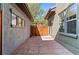 Exterior photo of private patio featuring stamped concrete, a wooden gate, and access to the backyard at 9804 Martin Luther King Blvd, Denver, CO 80238