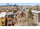 Urban living with views of the city skyline showcasing a red brick home with modern rooftop patio at 1763 N Williams St # 101, Denver, CO 80218