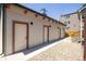 Backyard view of exterior doors, a rock garden and access to the main house at 1763 N Williams St # 101, Denver, CO 80218