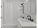 Modern bathroom featuring a shower with white subway tile and black fixtures at 1763 N Williams St # 101, Denver, CO 80218
