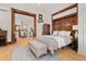Bedroom view showcasing hardwood floors, wooden trim and access to living areas at 1763 N Williams St # 101, Denver, CO 80218