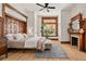 Bright bedroom boasts hardwood floors, large window and decorative fireplace at 1763 N Williams St # 101, Denver, CO 80218