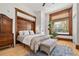Cozy bedroom featuring hardwood floors, a large window, and beautiful natural light at 1763 N Williams St # 101, Denver, CO 80218