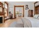 Spacious bedroom with wood accents, hardwood floors, and a view into other rooms at 1763 N Williams St # 101, Denver, CO 80218