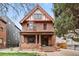 Charming two-story red brick home with a covered front porch and manicured lawn at 1763 N Williams St # 101, Denver, CO 80218
