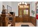 Grand foyer with ornate wood trim, a striking light fixture, and detailed staircase at 1763 N Williams St # 101, Denver, CO 80218