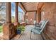 Inviting front porch with comfortable seating, stone columns, and patterned tile flooring at 1763 N Williams St # 101, Denver, CO 80218