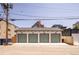 Exterior view of a four car garage with traditional overhead doors at 1763 N Williams St # 101, Denver, CO 80218