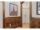 Elegant hallway featuring dark wood trim, hardwood floors, and decorative wall art at 1763 N Williams St # 101, Denver, CO 80218