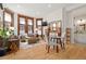 Cozy living room with hardwood floors, large windows, and an adjacent dining area at 1763 N Williams St # 101, Denver, CO 80218