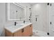 Modern bathroom featuring double sinks, a glass-enclosed shower, and contemporary fixtures at 1254 Yates St, Denver, CO 80204