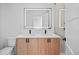 Bright bathroom featuring a double vanity, modern LED mirror, quartz countertops, and matte black hardware at 1254 Yates St, Denver, CO 80204