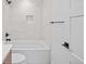 Bright bathroom showcases a tub, tiled walls, modern fixtures and a convenient towel bar at 1254 Yates St, Denver, CO 80204