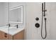 Modern bathroom featuring dual sinks, illuminated mirror and shower with sleek black hardware at 1254 Yates St, Denver, CO 80204