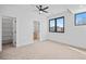 Bright bedroom with large windows, neutral carpet, and attached bathroom at 1254 Yates St, Denver, CO 80204